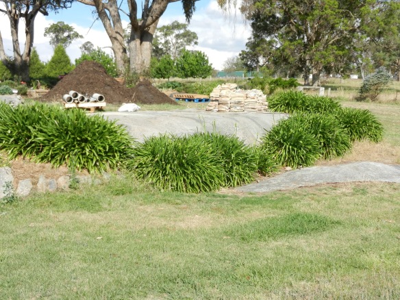 Before area where lower pond was put - plus materials for use in the garden